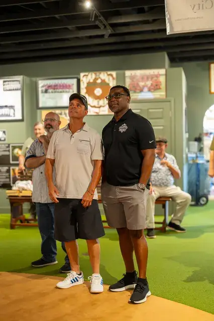 Two men look up at the exhibits.