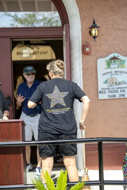 A guest steps up to the porch by the Depot entrance.