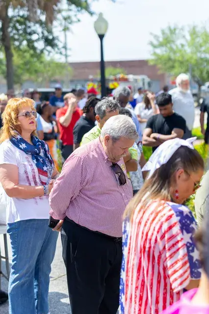Guests bow their heads during the invocation.