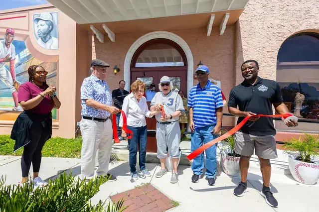 The ribbon falls as the officials cut it in front of the Depot.