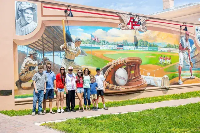 The family in front of the mural, wider.