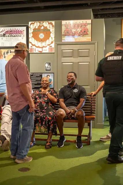 Guests seated in the gallery with a deputy.