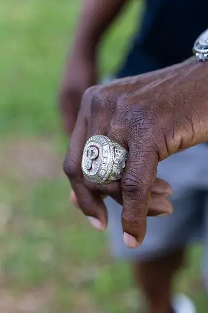 A hand wearing a championship ring.