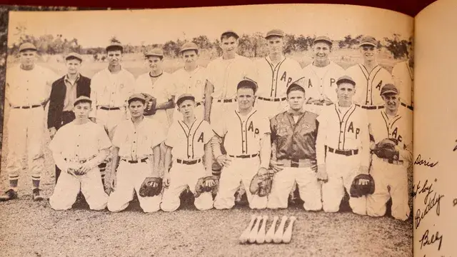 A vintage team photograph of players in AP uniforms.