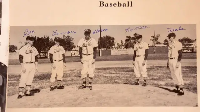 A yearbook page showing five Devils players, signed in blue ink.
