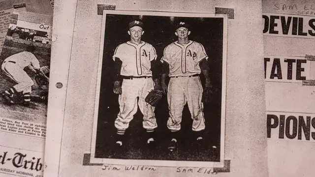 A newspaper photograph of two players in AP uniforms, captioned Jim Waldron and Sam Elder.
