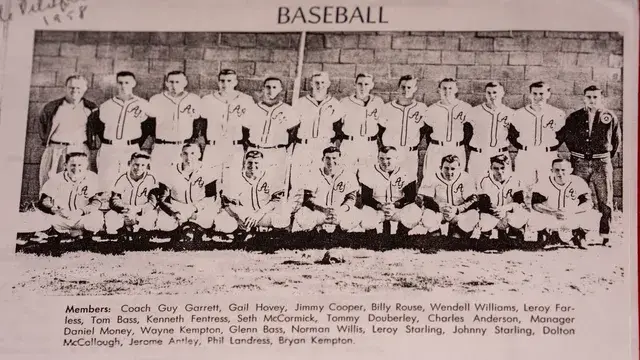 A yearbook baseball team photograph with the roster printed beneath.