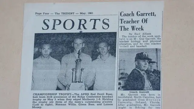 The Trident, May 1961: Coach Garrett, Teacher of the Week, with the championship trophy.