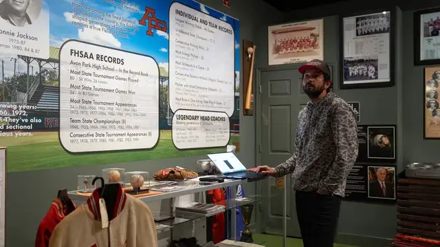 The man at the laptop display beneath the records panel.
