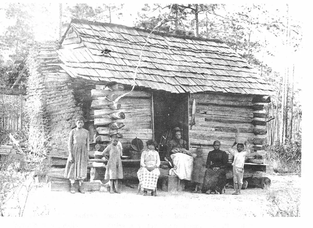 A typical log cabin, shack built for a colored family living at Hagan’s turpentine still which was located